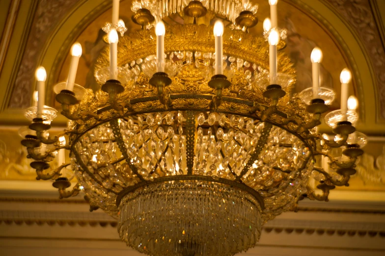 a chandelier hangs from the ceiling in a room with lights