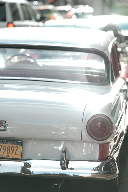 many old cars sit parked next to each other