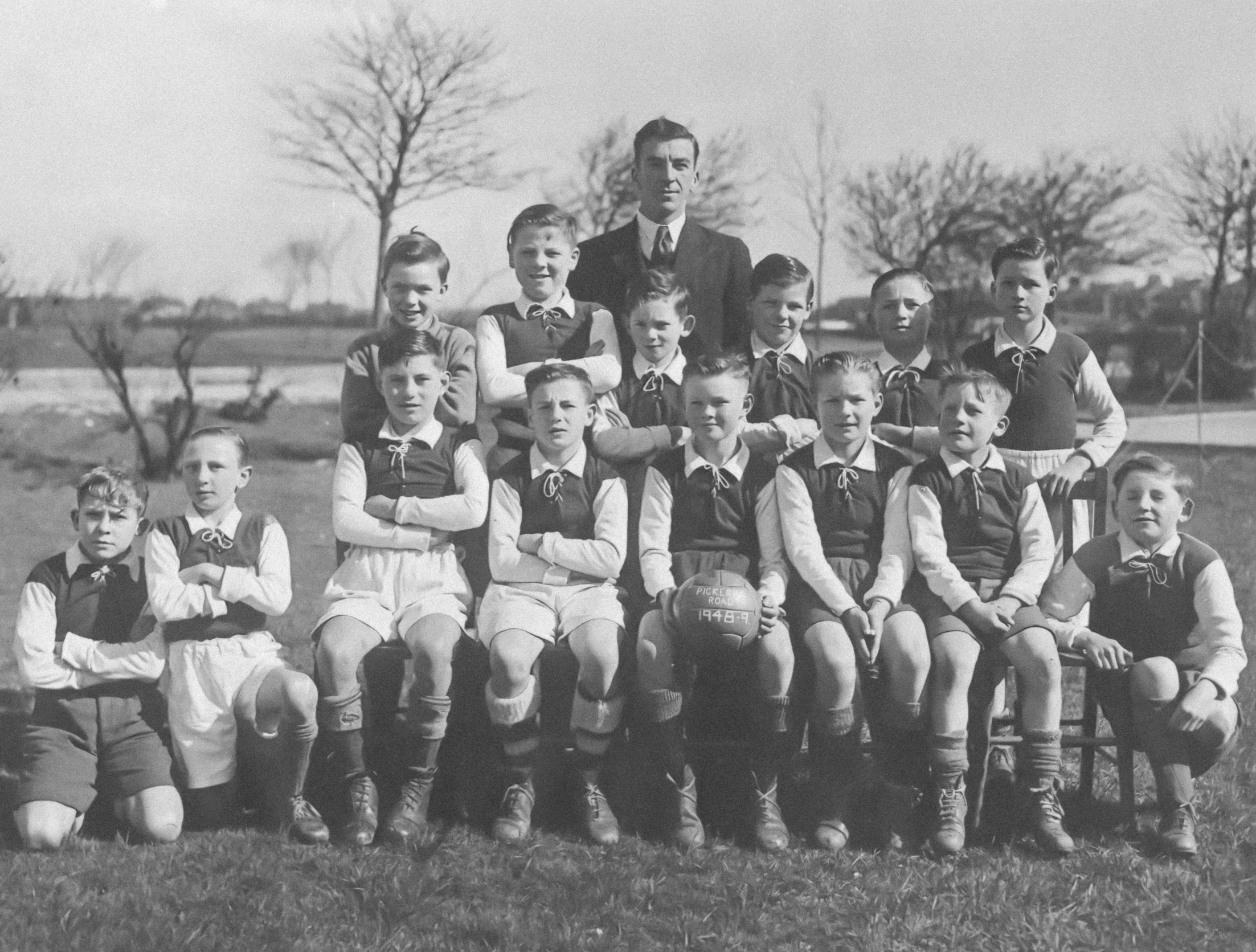 group of children in uniforms posing for a po