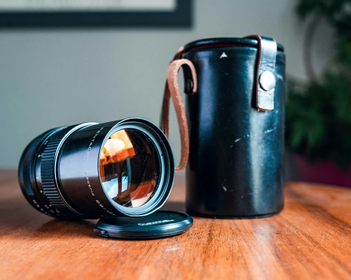 the lens is being placed in front of the coffee cup