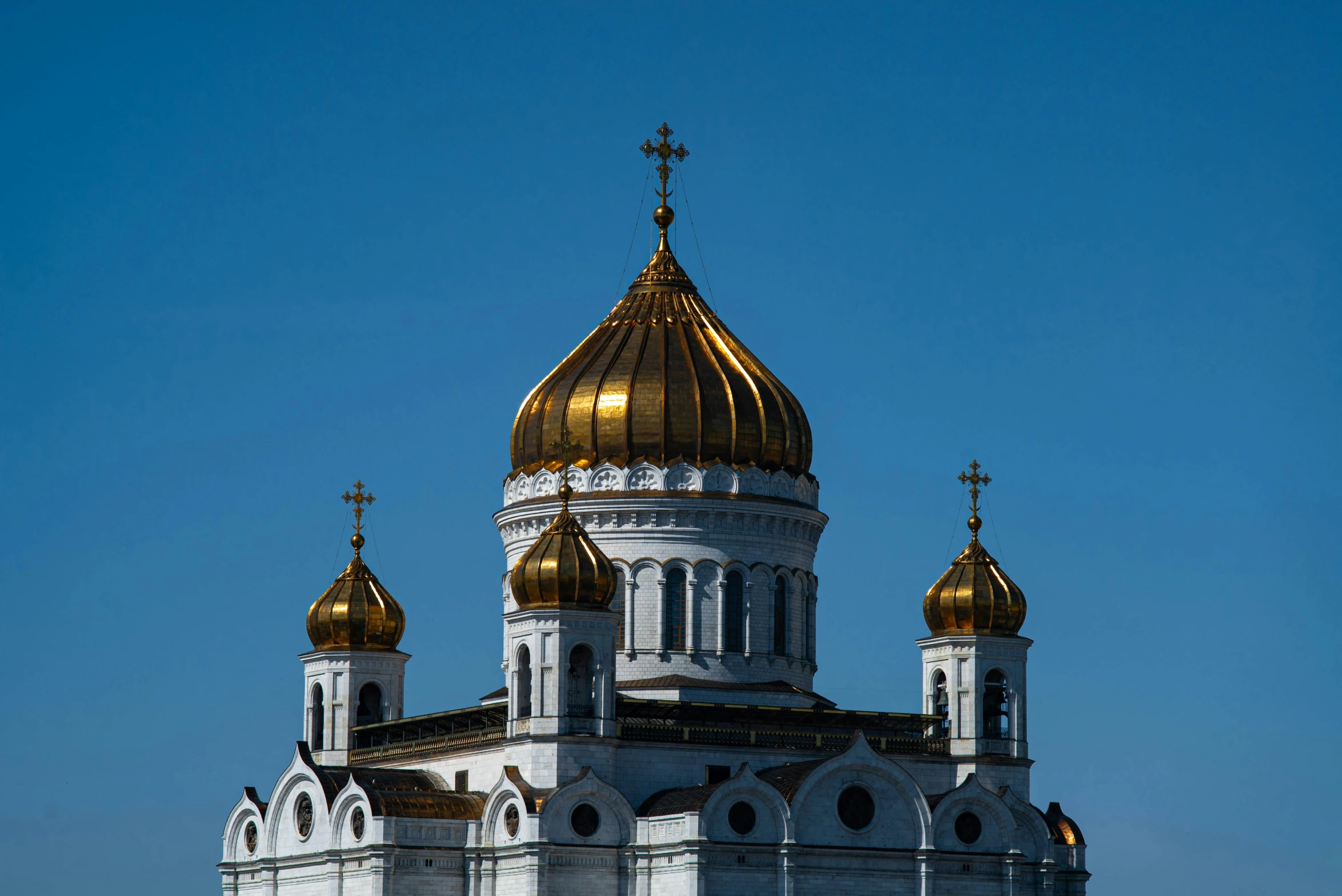 a very pretty church with two towers under a blue sky