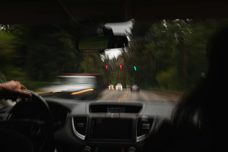 view from inside a vehicle looking at a blurred road