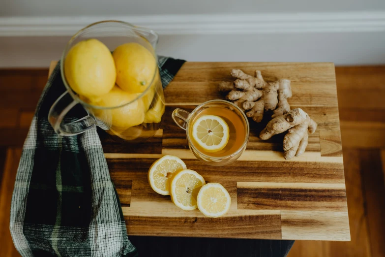 a wooden  board with sliced lemons next to it