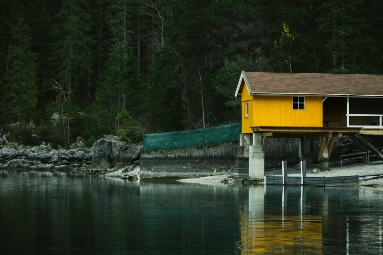 a house sitting on stilts over the water