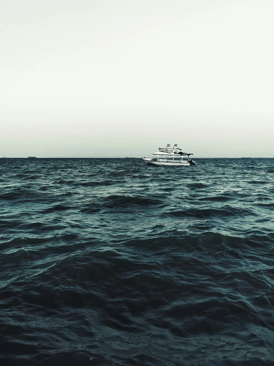 a boat sails out on the open ocean