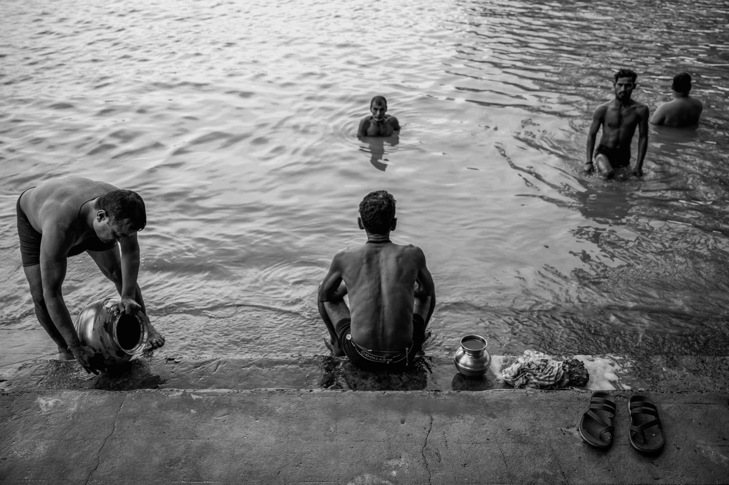 black and white pograph of men with two children