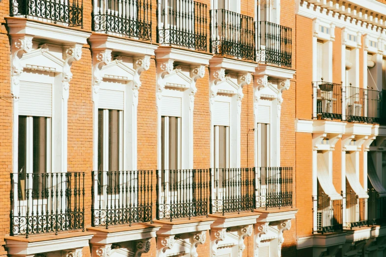 an orange and white building with multiple balconies