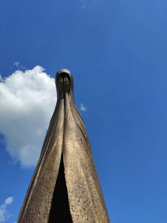 an ornate thatched roof with a bright blue sky