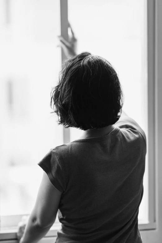 a person in the dark standing near a window