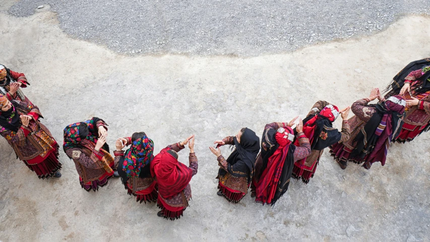 five women in colorful clothing standing next to each other