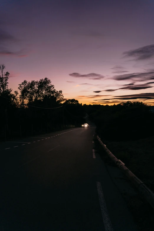 a black and purple sky with car lights