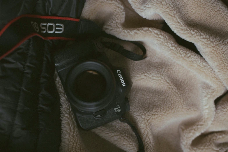 a camera is placed next to a jacket