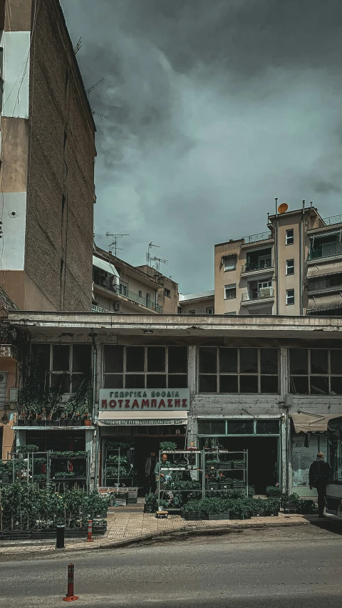 a tall brick building sitting in front of two tall buildings