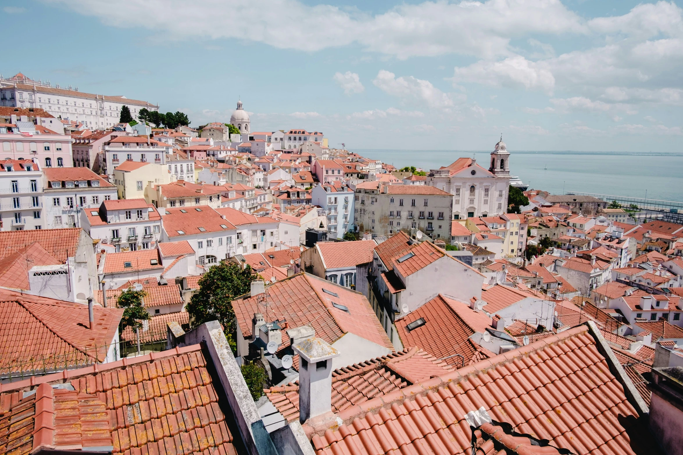 view from the top of a hill of old houses overlooking water