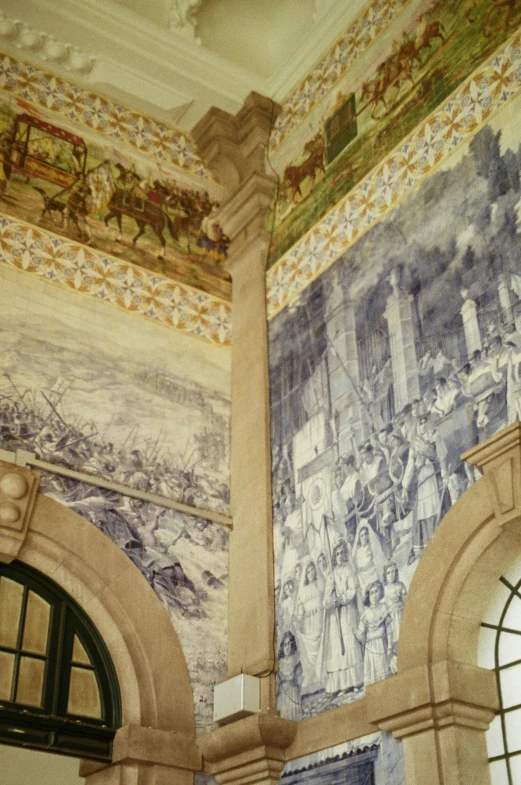 ornate murals decorate the walls and ceilings of an older building