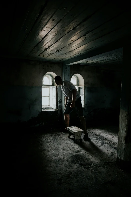 a man riding a skateboard through a dark room