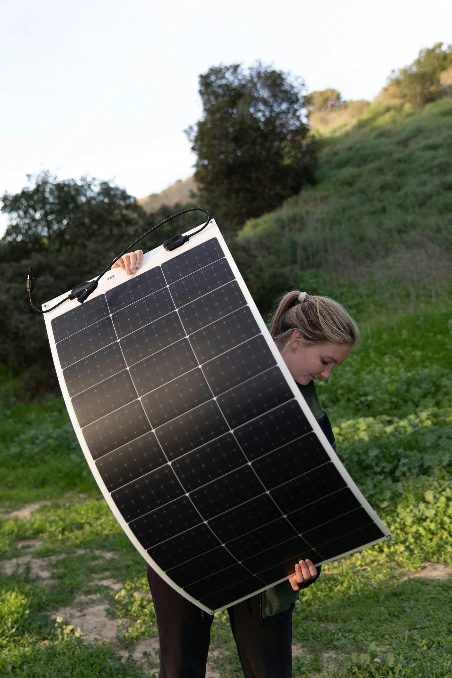 a woman is carrying a very large sheet of solar