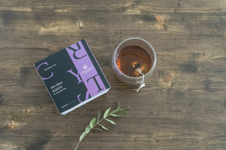 a book and glass of tea on a table