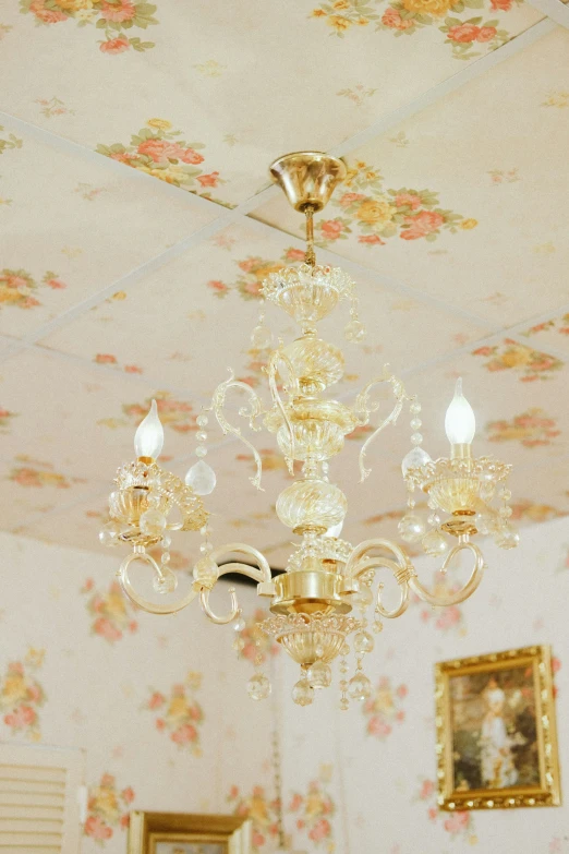 a chandelier hangs from the ceiling of an ornately decorated room