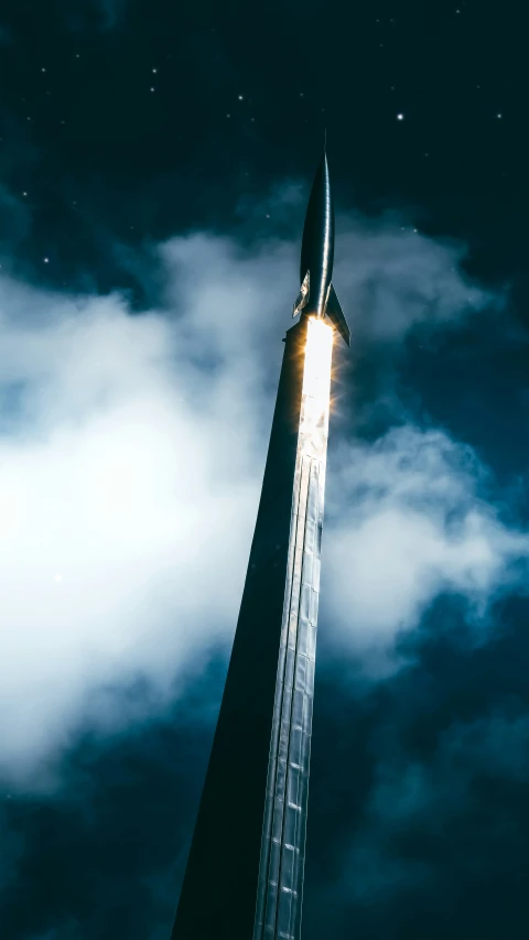 a very tall building with a massive pointed rocket on it's side