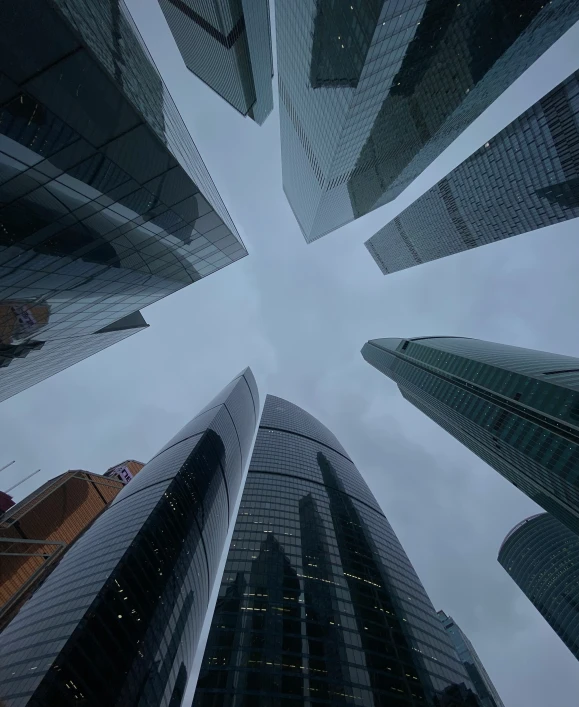 an upward view looking up at skyscrs in london