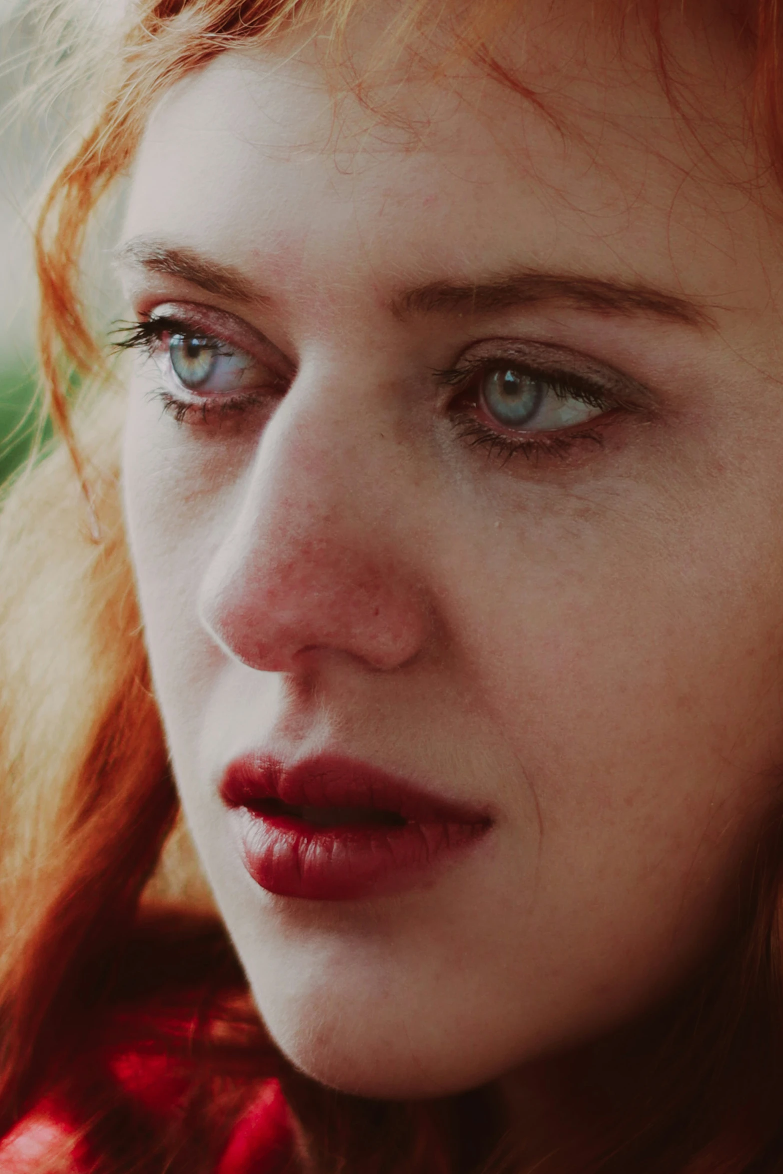 a close up po of a young red headed woman