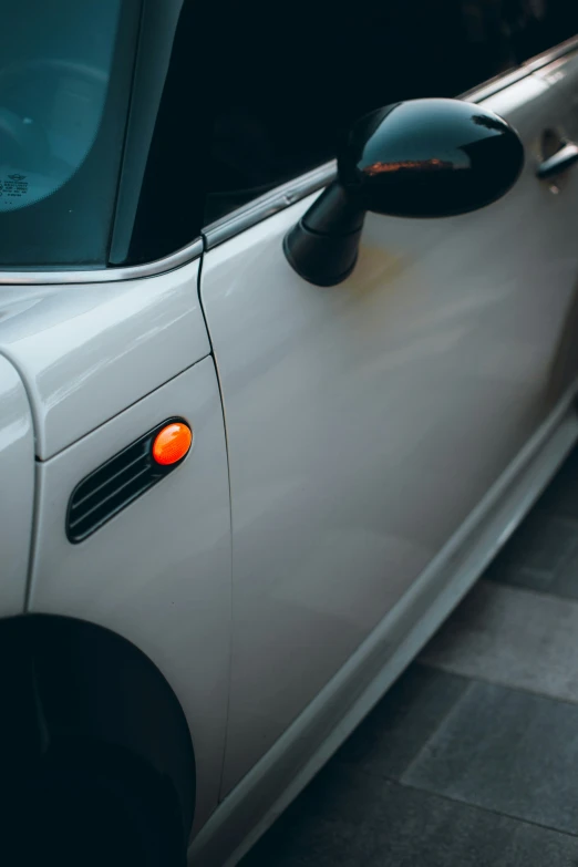 a white car parked next to a black car