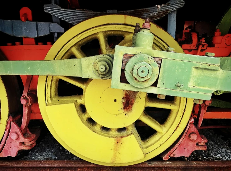 an old train engine painted yellow and red