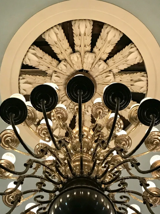 the chandelier is designed with circular accents and is hand made