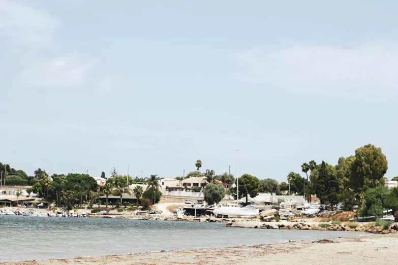 the beach in front of the ocean with the water in view