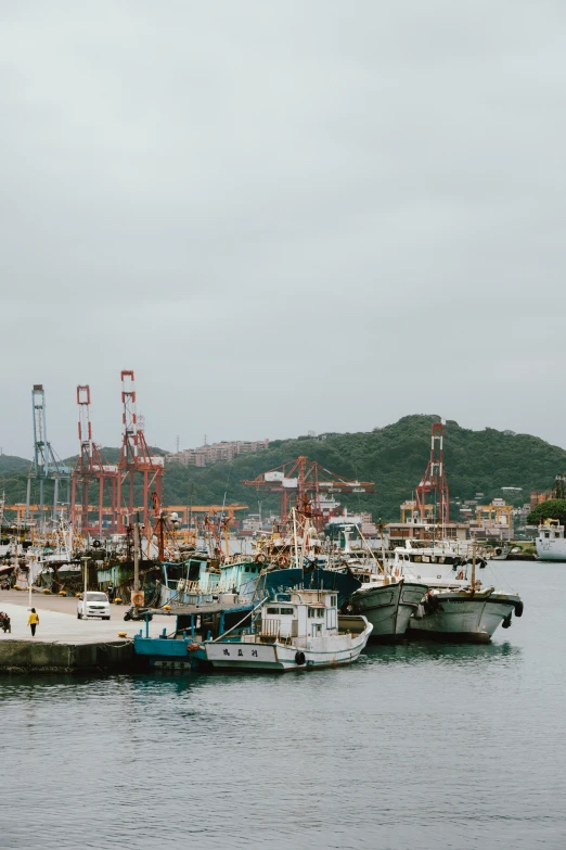 some boats are docked next to each other in the water