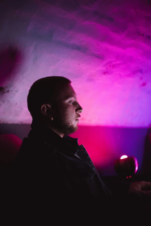 a man sitting at a table in a room with lights on