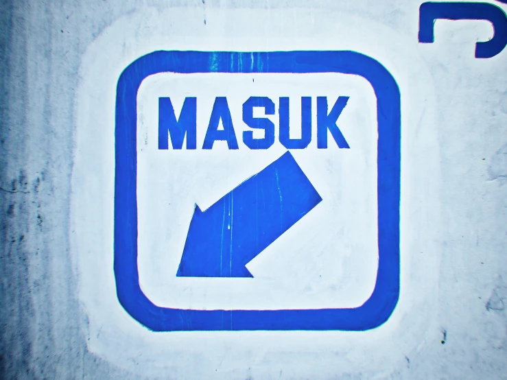 a closeup of a blue and white sign with the words masuk