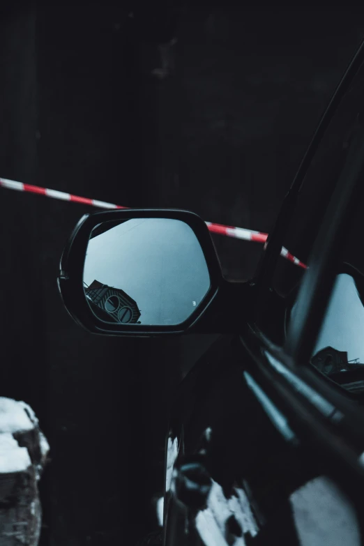 a car mirror sitting in front of a vehicle