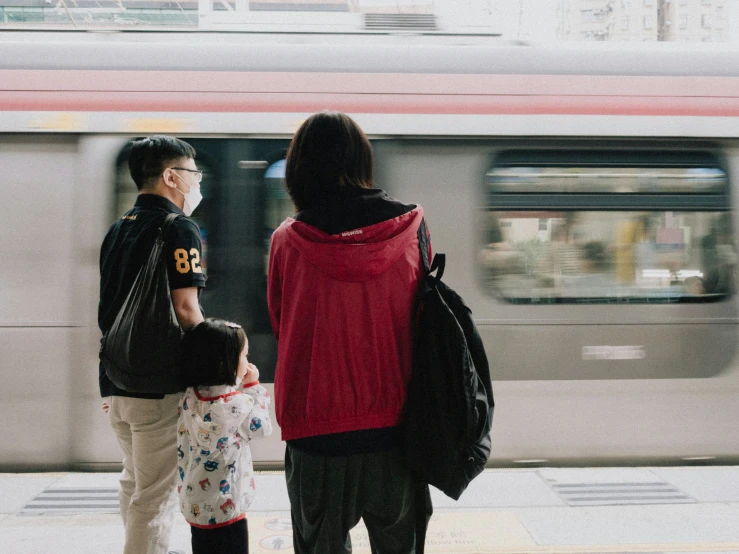 a man and woman standing next to each other on a train platform