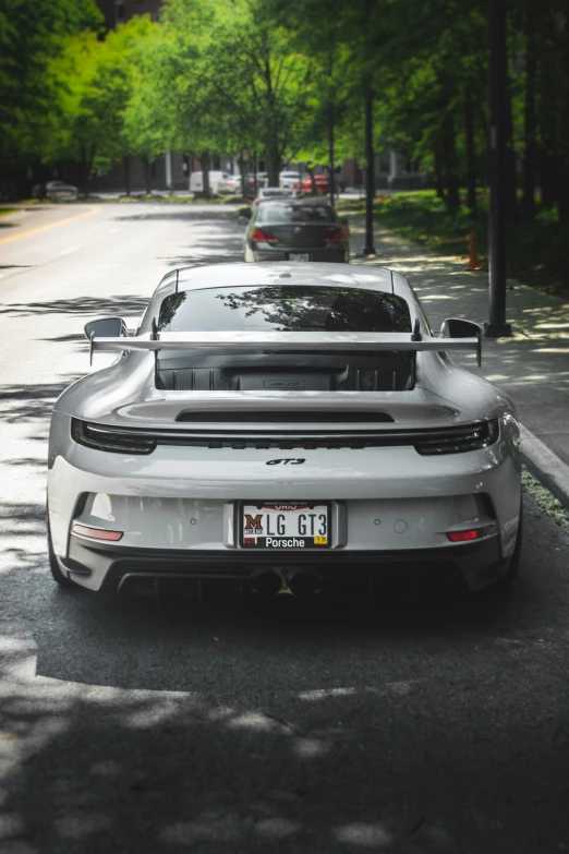 a sports car is shown driving down the street