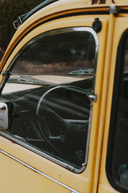 an old yellow bus with a person looking out the window