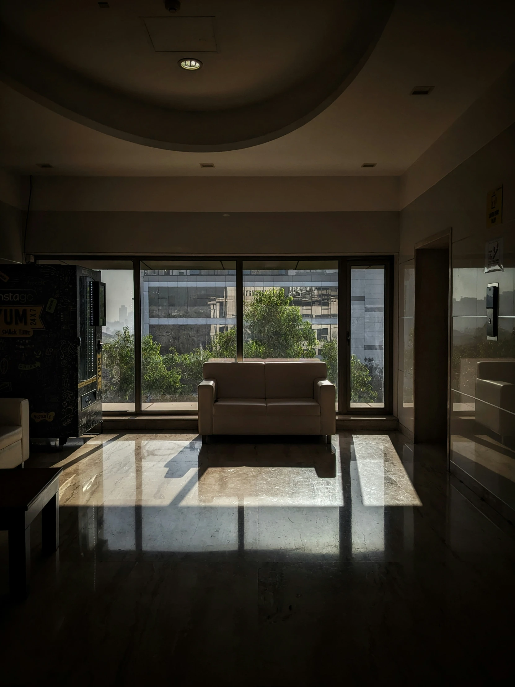 the light shines on the floor in front of the couch