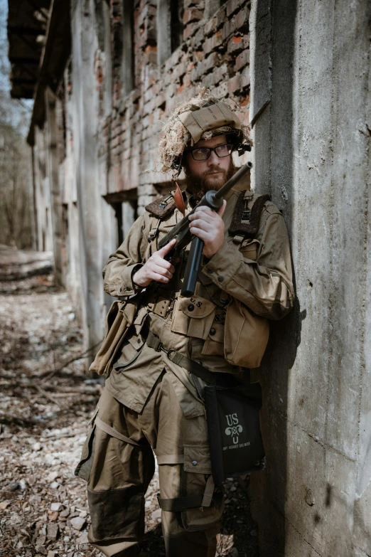 a soldier posing for the camera in a run down building