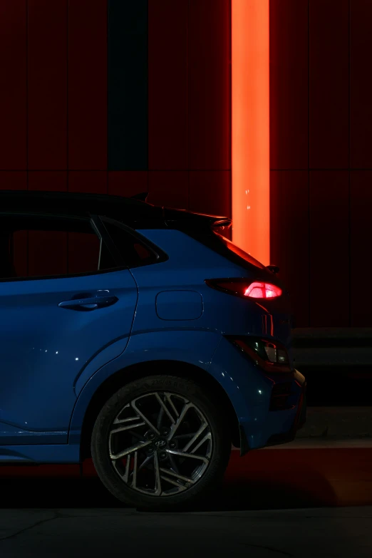a blue car parked next to red lights