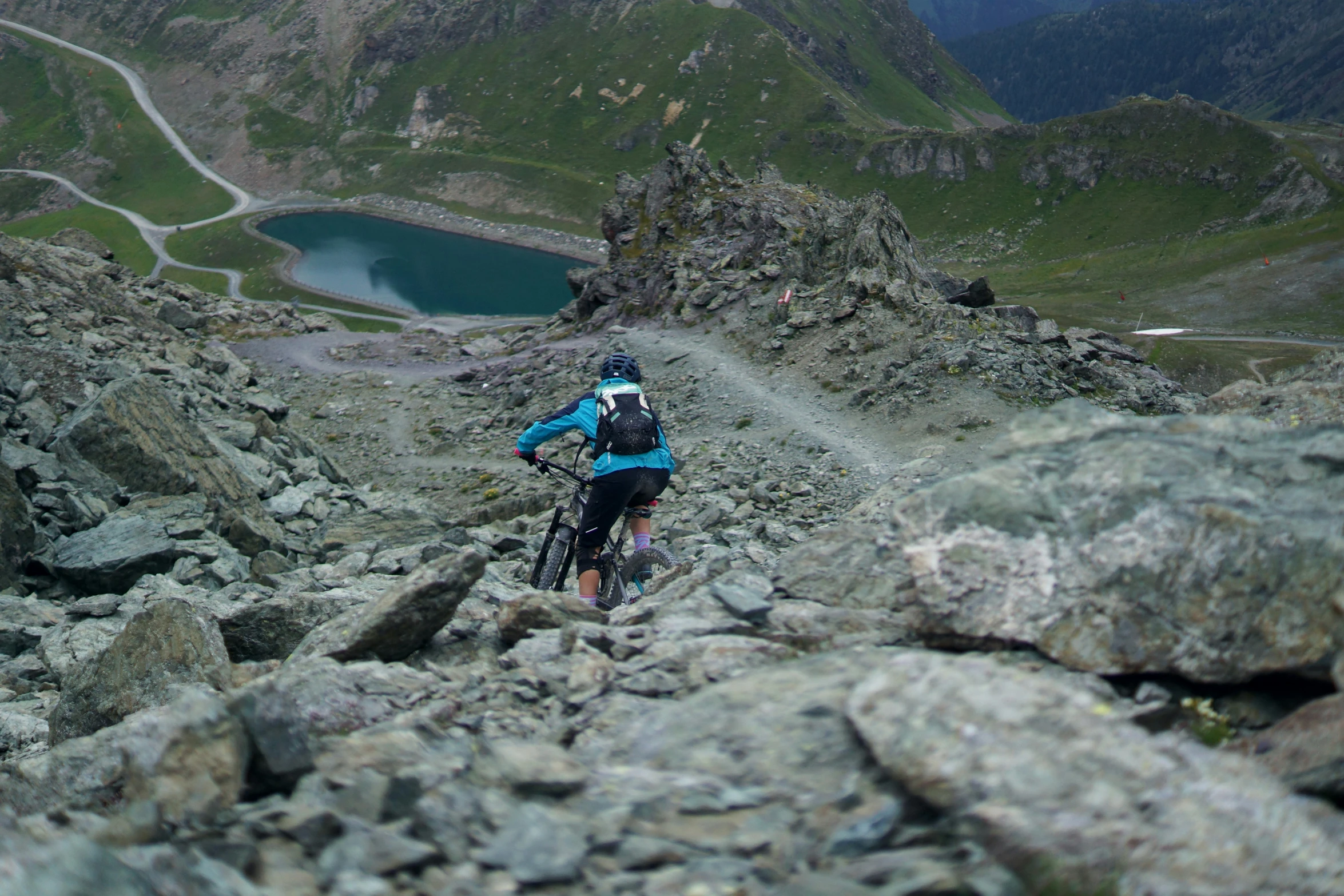 there is a man riding a bike on the rocks