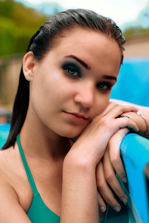 a pretty girl with blue eyes in green