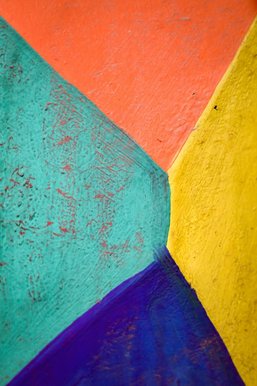 a multicolored wall with a red and blue object in the middle