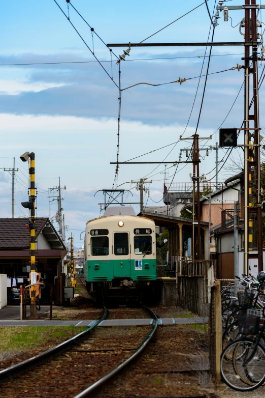 green and white train passing through an urban city