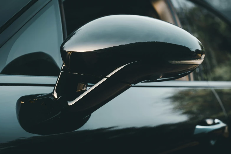 a helmet shaped mirror on the side of a car