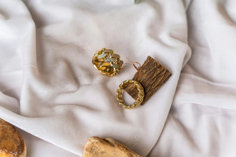 various jewelry sitting on top of a white cloth