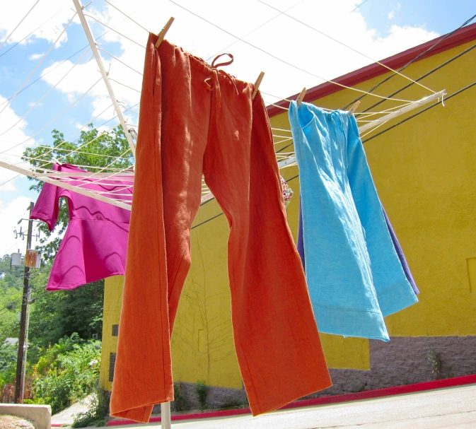 three clothes hanging out to dry in front of a house