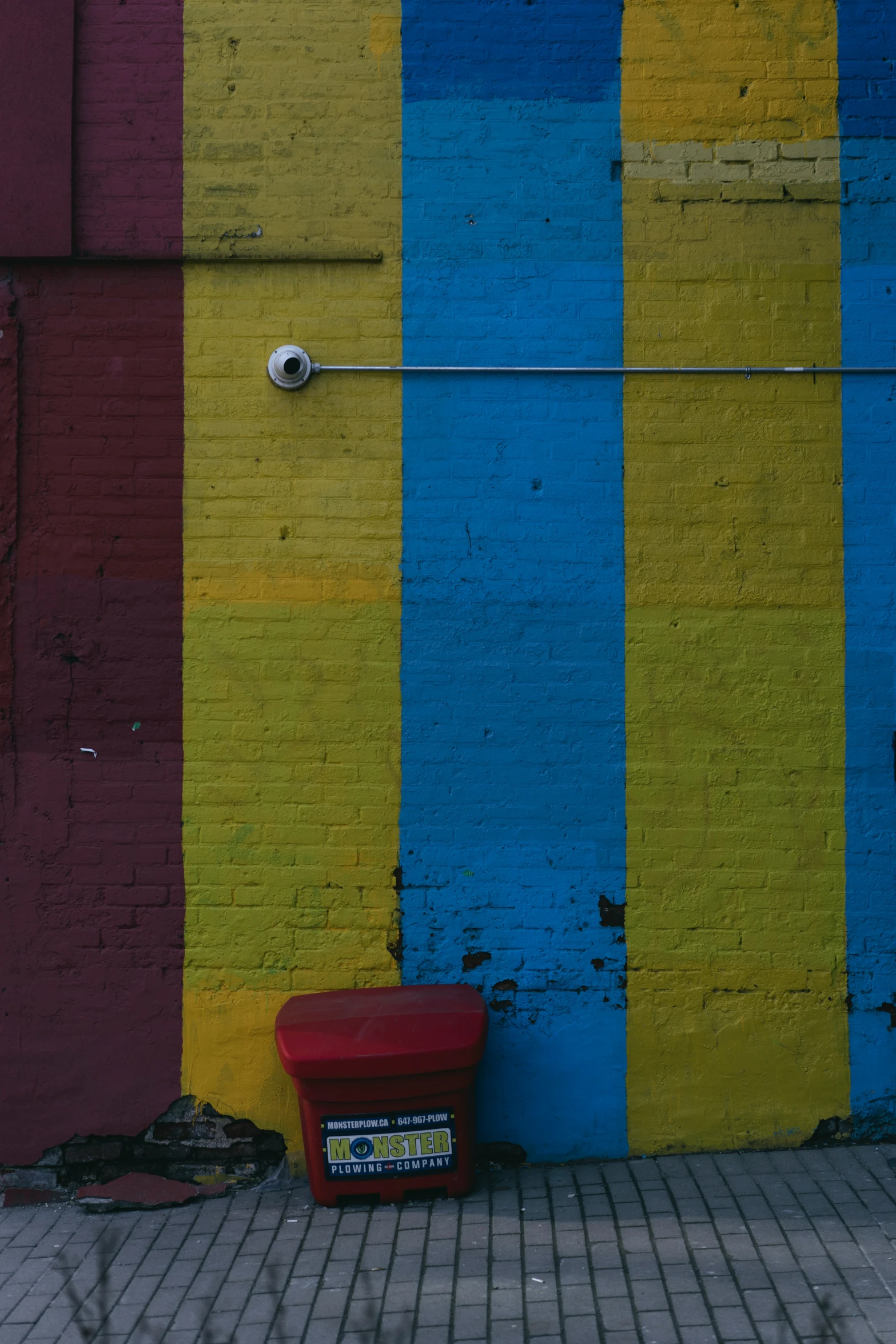 a painted wall with a bench against it