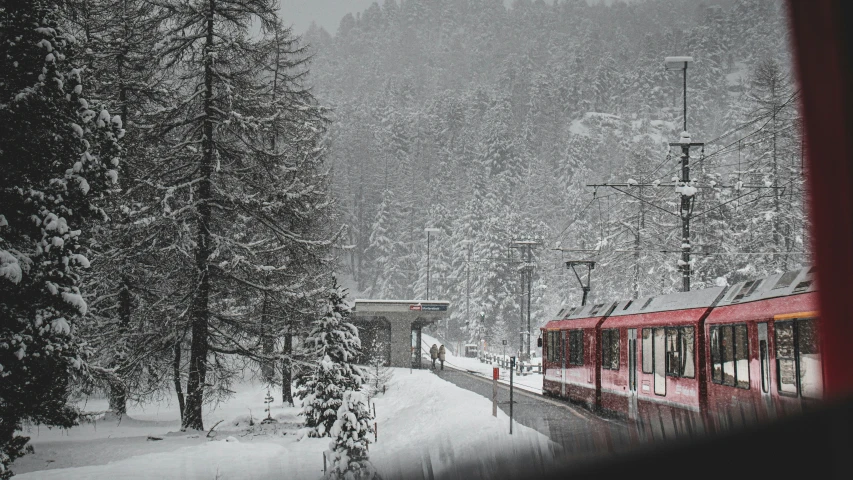 a train rides on some tracks on a snowy day