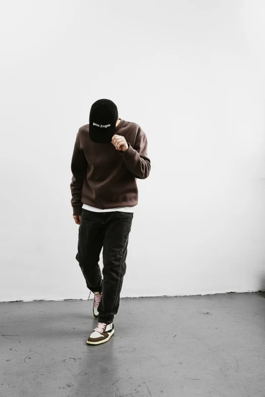 a person in a black and brown sweater skating